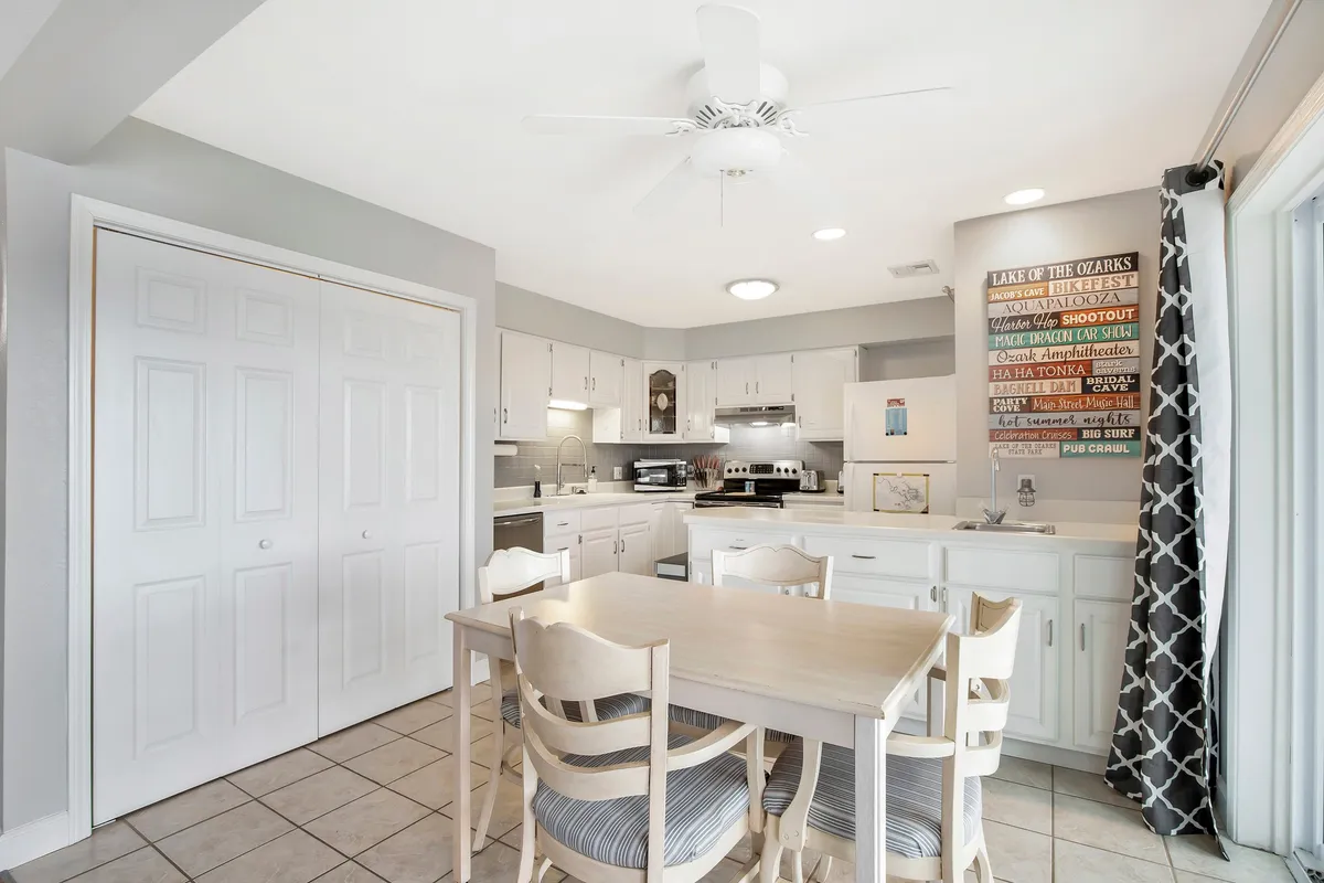 A cozy dining space featuring a dining table adjacent to visible kitchen appliances and decorated with wall art. The setup is clearly designed for family meals, gatherings, and social occasions.